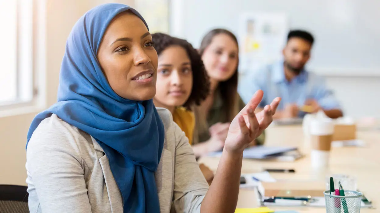 A woman speaking during a meeting.