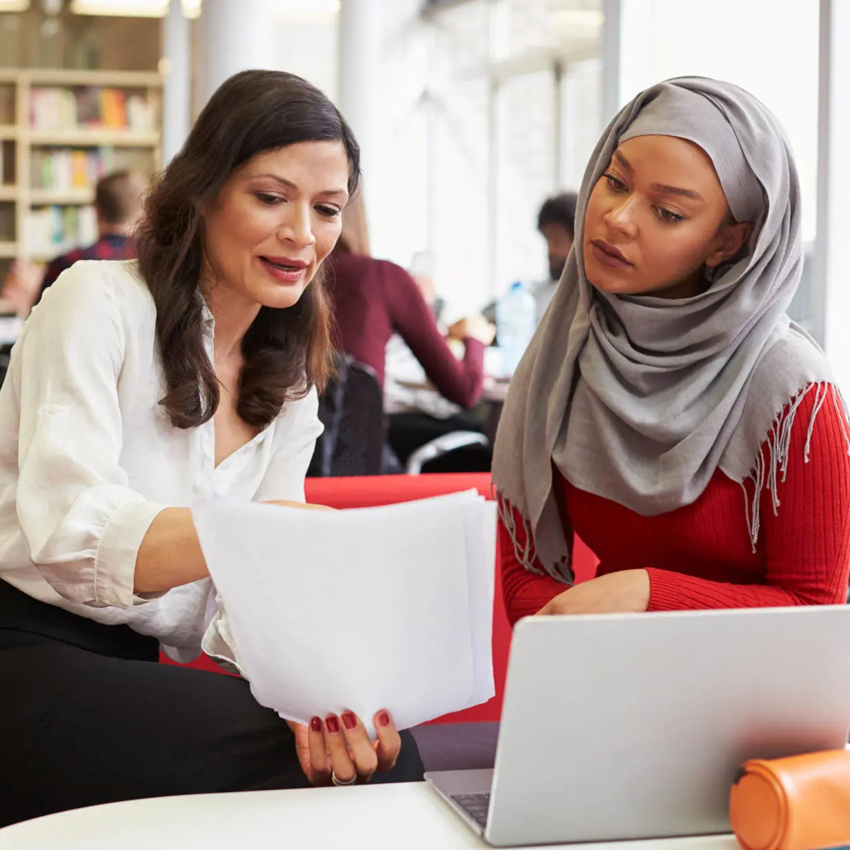 Two women having a conversation at work. 