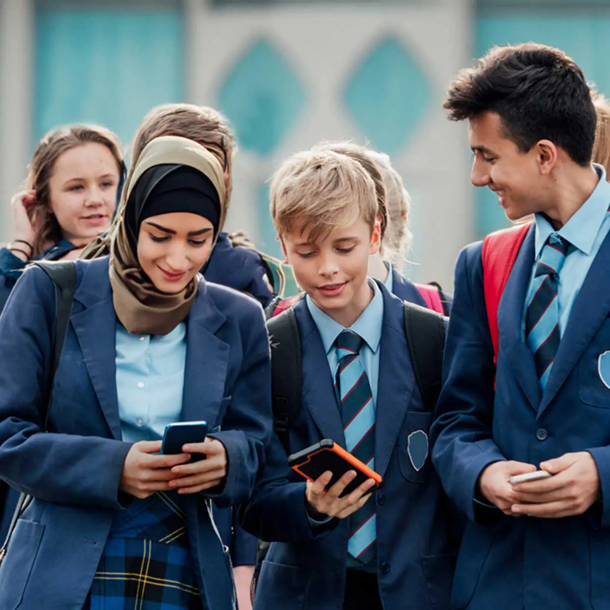 Group of students using their phones.
