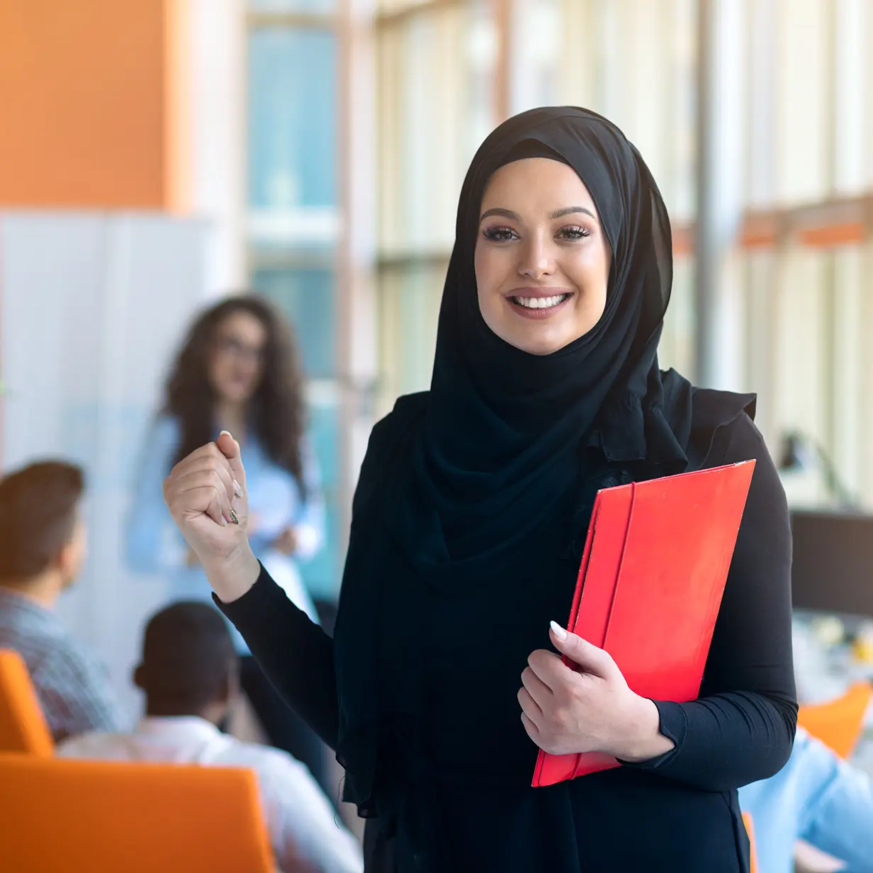Educational professional holding a folder.