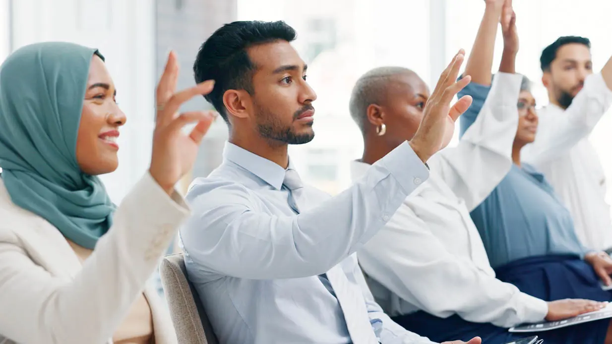 A group of people raising their hands. 