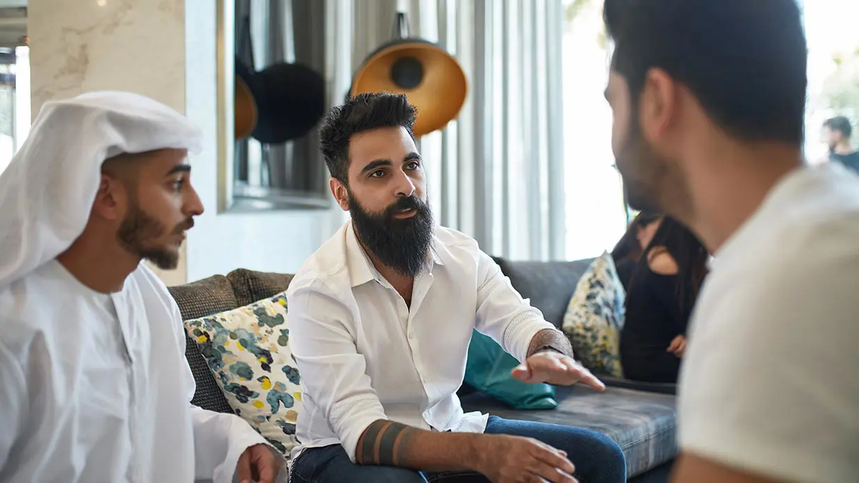Three men having a serious conversation.