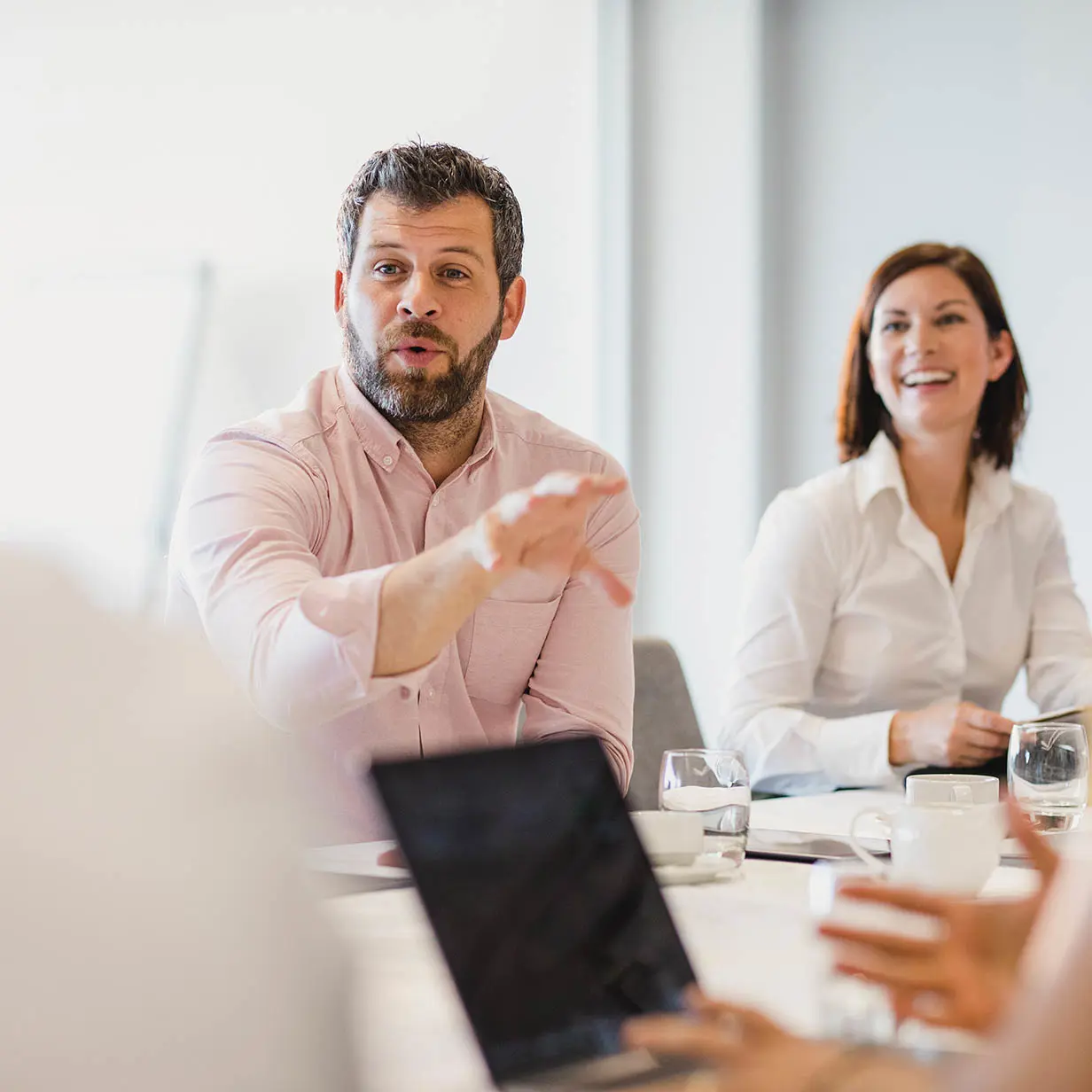A man speaking during a meeting. 