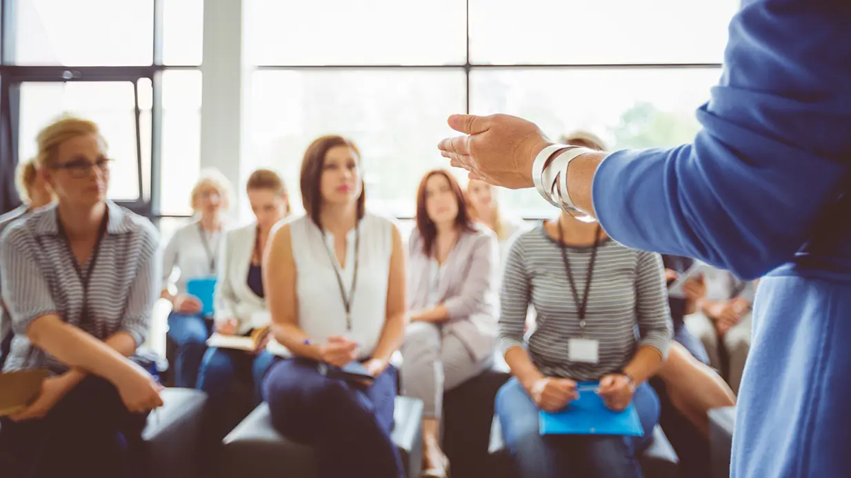 Audience listening to professional speaker.