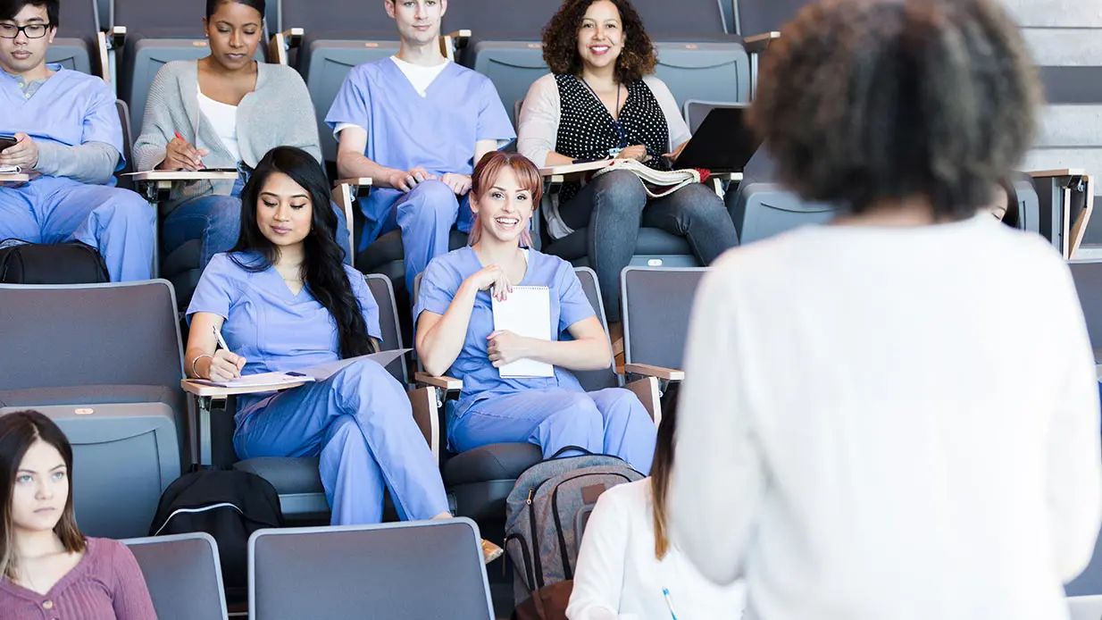 A dentist, hygienist, and a patient talk.