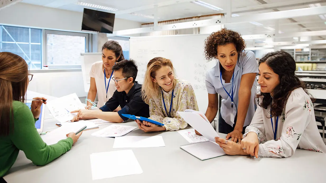 A group of people around a conference table. 