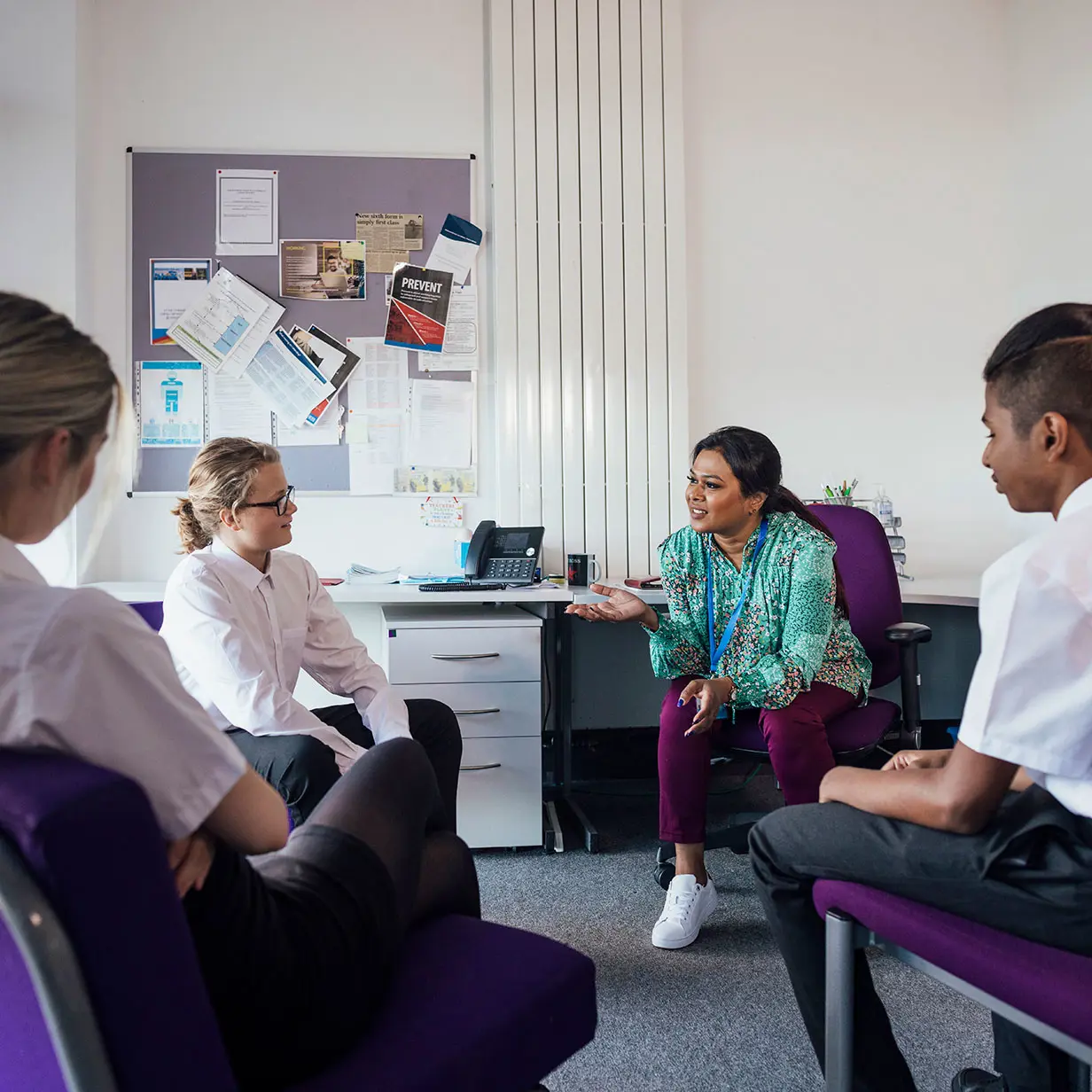 Four people sitting in the round having a conversation. 